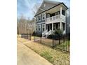 Beautiful two-story home featuring a covered porch, black fence and neutral exterior at 615 R L Stowe Rd, Belmont, NC 28012