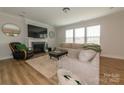 Bright living room boasts a fireplace, a plush rug, and modern furniture at 615 R L Stowe Rd, Belmont, NC 28012