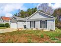 Charming home featuring a manicured lawn, covered entryway, and attached one car garage at 7918 Travers Run Dr, Charlotte, NC 28215