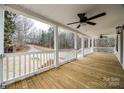 Spacious porch with wooden floors, white railings, and a view of the wooded surroundings at 801 Sandifer Rd, York, SC 29745