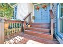 Inviting covered front porch with wooden steps and decorative flower pots at 8210 Mattingridge Dr, Charlotte, NC 28270