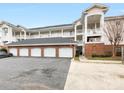 Condominium exterior showcasing garages and covered balconies at 8759 Coralbell Ln, Charlotte, NC 28213