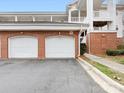 Garage area with brick accents and ample parking space at 8759 Coralbell Ln, Charlotte, NC 28213
