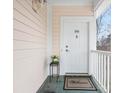 Charming porch view with welcome mat, flowers, and the unit number at 8759 Coralbell Ln, Charlotte, NC 28213