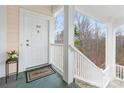 Charming porch view with welcome mat and flowers at 8759 Coralbell Ln, Charlotte, NC 28213