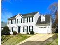 Lovely home with an attached garage and a driveway leading to the front, framed by lush greenery at 9146 Austin Ridge Ln, Charlotte, NC 28214