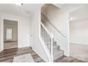 Bright foyer featuring neutral walls, carpeted stairs, and wood-look flooring, creating a welcoming entrance at 9146 Austin Ridge Ln, Charlotte, NC 28214