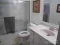 Standard bathroom featuring a shower-tub, white commode and sink with faucet, framed artwork and neutral color palette at 9808 Arbor Dale Ave, Charlotte, NC 28215