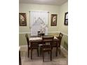 Charming dining area with decorative window treatment and floral artwork creating a warm ambiance at 9808 Arbor Dale Ave, Charlotte, NC 28215