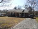 Lovely brick house with a paved driveway and welcoming curb appeal at 9808 Arbor Dale Ave, Charlotte, NC 28215