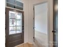 Bright entryway with hardwood floors, a stylish front door, and an open doorway to the next room at 0004 Mission Church Rd, Locust, NC 28097