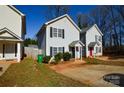 Street view of a well-maintained home featuring a symmetrical facade, tidy landscaping, and inviting curb appeal at 1008 Beaugard Dr, Charlotte, NC 28208