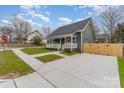 Inviting home with a spacious driveway and well-kept front lawn at 102 S Liberty St, Gastonia, NC 28052