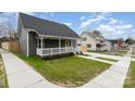 Quaint home with a covered front porch and a neatly landscaped yard at 102 S Liberty St, Gastonia, NC 28052