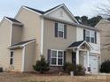 Attractive two-story home with neutral siding, black shutters, and a cozy front porch at 1301 Waylon Ave, Gastonia, NC 28054