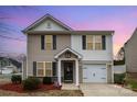 Charming two-story home features a front-facing garage, well-maintained lawn and a welcoming entrance at 1301 Waylon Ave, Gastonia, NC 28054