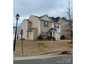 Two-story home with neutral siding, manicured lawn, and an attached garage at 1301 Waylon Ave, Gastonia, NC 28054