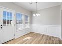 Bright dining area featuring new flooring, elegant chandelier, and trim at 136 Ridge Bluff Rd, Mooresville, NC 28115