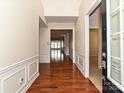 Inviting entrance hall with hardwood flooring and wainscoting leading into the light-filled living area at 14309 Stonewater Ct, Fort Mill, SC 29707