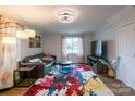 Bright living room featuring stylish furnishings, a TV, and natural light from the window at 1611 Old Hickory Grove Rd, Mount Holly, NC 28120