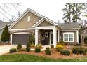 Charming home featuring a well-maintained front yard and attached two-car garage at 16116 Lakeside Loop Ln, Cornelius, NC 28031