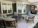 Relaxing outdoor patio featuring comfortable seating, a coffee table, and a stylish rug, perfect for entertaining at 16116 Lakeside Loop Ln, Cornelius, NC 28031
