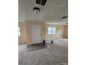 Open-concept living room with natural light, neutral color paint, carpeted floors and an entrance door at 1806 Little Rock Rd, Charlotte, NC 28214