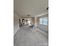 Bright living room featuring carpet flooring and walls painted in neutral colors at 1806 Little Rock Rd, Charlotte, NC 28214