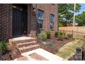 Stylish brick facade with manicured landscaping, and entry steps at 210 Gilead Rd, Huntersville, NC 28078