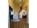 Elegant foyer with a curved staircase, hardwood floors, and high ceilings at 2379 Metcalf Dr, Sherrills Ford, NC 28673