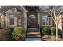 Inviting front entrance featuring a brick stairway, arched entryway, brick and stone pillars at 2379 Metcalf Dr, Sherrills Ford, NC 28673