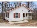 Charming one-story home featuring white siding, red roof, and a cozy front porch at 2407 Moose Rd, Kannapolis, NC 28083