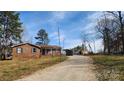 Wide view of a ranch-style house with a gravel driveway leading to the home at 3272 Hunter Ridge Rd, Rock Hill, SC 29732