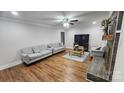 Bright living room with hardwood floors, neutral-colored sofas, and a modern fireplace at 3272 Hunter Ridge Rd, Rock Hill, SC 29732