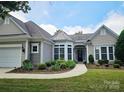 Well-maintained home featuring a manicured lawn, mature landscaping, and an attached two-car garage at 36112 Watsonia St, Fort Mill, SC 29707