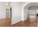 Bright hallway featuring wood floors, white walls, and decorative trim at 36112 Watsonia St, Fort Mill, SC 29707