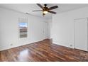 Bright bedroom featuring wood-look floors, ceiling fan, and window at 517 S Central Ave, Landis, NC 28088