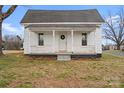 Charming home featuring a quaint front porch with classic architectural details at 517 S Central Ave, Landis, NC 28088