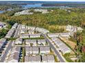 An aerial view of a well-planned neighborhood surrounded by lush greenery and a serene lake at 574 Altamonte Dr, Clover, SC 29710