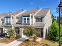 Charming townhome featuring a stone-accented facade, well-manicured landscaping, and an attached one-car garage at 574 Altamonte Dr, Clover, SC 29710