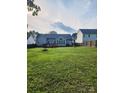 Expansive backyard with a wooden fence, well-kept lawn, and an inviting deck area at 5834 Coopers Ridge Ln, Charlotte, NC 28269