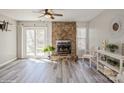 Bright living room featuring a stone fireplace, sliding glass doors, and modern flooring at 6212 Windsor Gate Ln, Charlotte, NC 28215