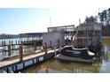 Private boat dock features a lift and jet ski space, granting direct water access for recreational activities at 752 Pinehaven Dr # 105, New London, NC 28127