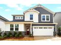 Inviting two-story home with grey and white siding, a two-car garage, and a well-maintained front yard at 9930 Cask Way, Huntersville, NC 28078