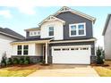 Attractive two-story home featuring mixed siding, a two-car garage, and manicured landscaping at 9930 Cask Way, Huntersville, NC 28078