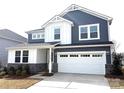 Exterior elevation shows a lovely home with a two-car garage and stone accents at 9930 Cask Way, Huntersville, NC 28078