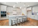 Bright, open kitchen with an island, sleek countertops, stainless steel appliances, and pendant lighting at 9930 Cask Way, Huntersville, NC 28078