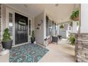 Inviting front porch with stone pillars and a colorful rug, perfect for enjoying the outdoors at 1048 Harbor Bay Dr, Indian Land, SC 29707