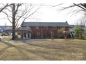 Spacious backyard featuring a covered patio, offering ample space for relaxation and outdoor activities at 1060 Laurel Ln, Gastonia, NC 28054