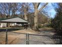 Fenced backyard features a covered area, providing privacy and space for outdoor enjoyment at 1060 Laurel Ln, Gastonia, NC 28054